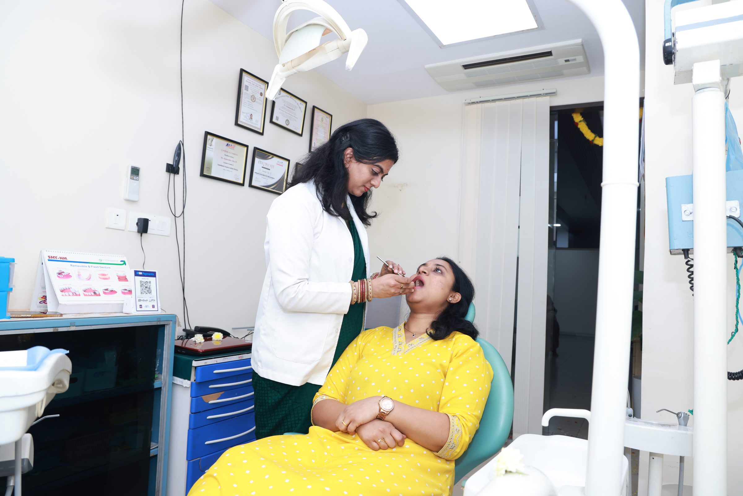 Dr. Sushmitha examining a patient in the treatment chair at Smithara Dental Care
