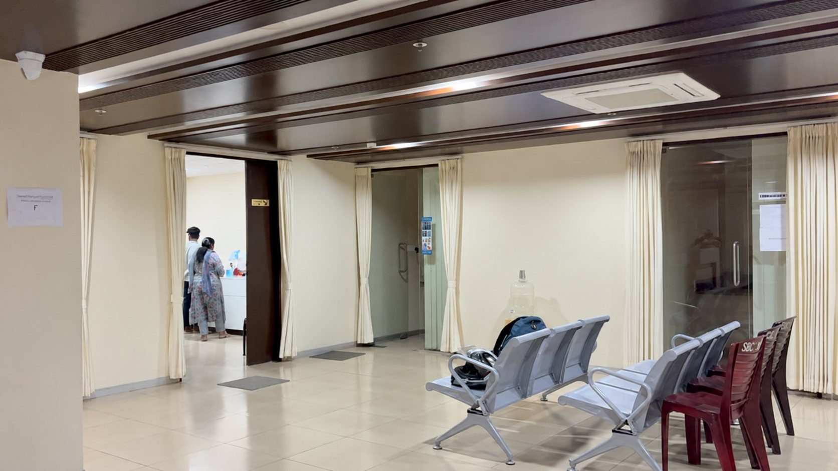 The Smithara Dental Care waiting area with patient seating, cream curtains and a clean tiled floor